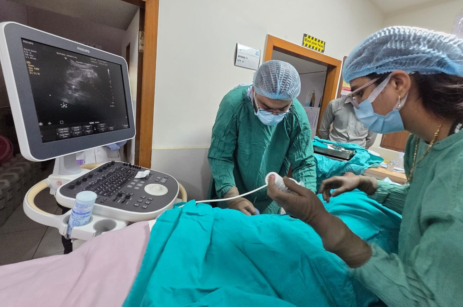 Dr. Harshita Sharma, Nephrologist at Bansal Hospital Bhopal, performing a kidney procedure with ultrasound guidance.